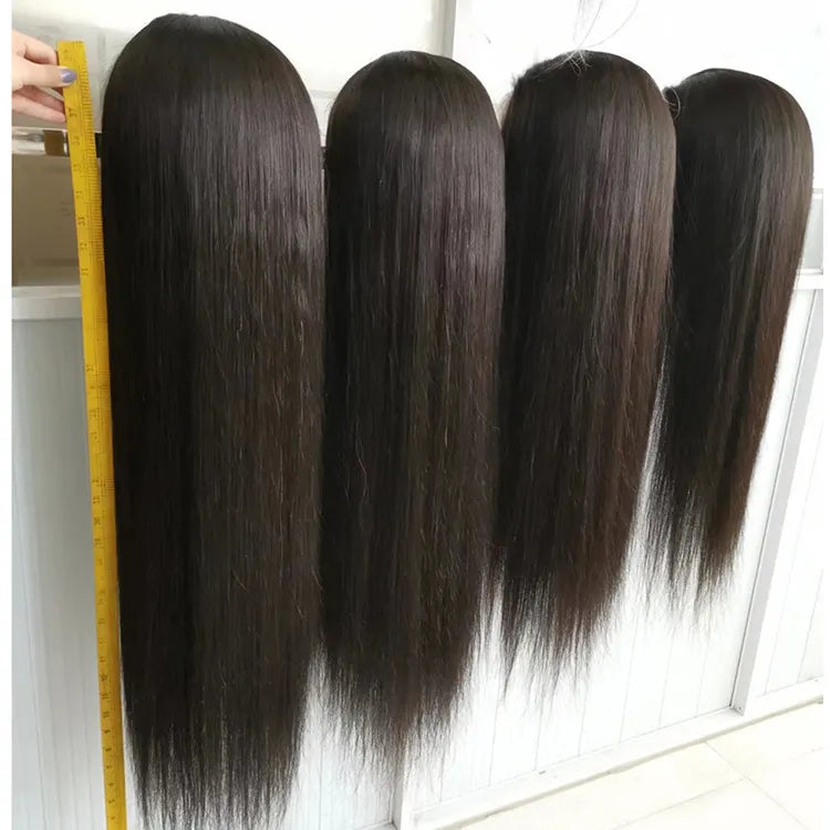 Four bundles of straight hair with a measuring tape on a white background